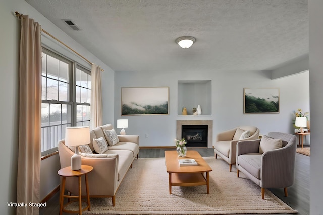 1852 Meadowlawn Dr, Columbus, OH 43219 - living area featuring wood finished floors, a textured ceiling, and a glass covered fireplace