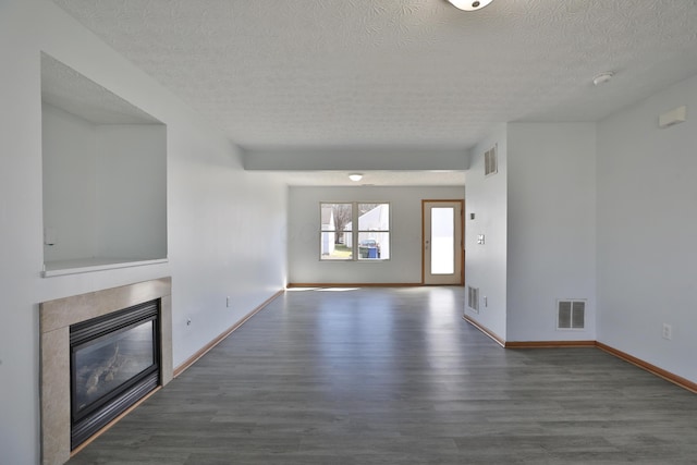 1852 Meadowlawn Dr, Columbus, OH 43219 - unfurnished living room featuring a textured ceiling, wood finished floors, and a glass covered fireplace