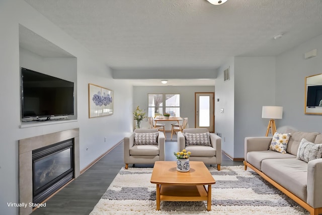 1852 Meadowlawn Dr, Columbus, OH 43219 - living area featuring wood finished floors, a glass covered fireplace, and a textured ceiling