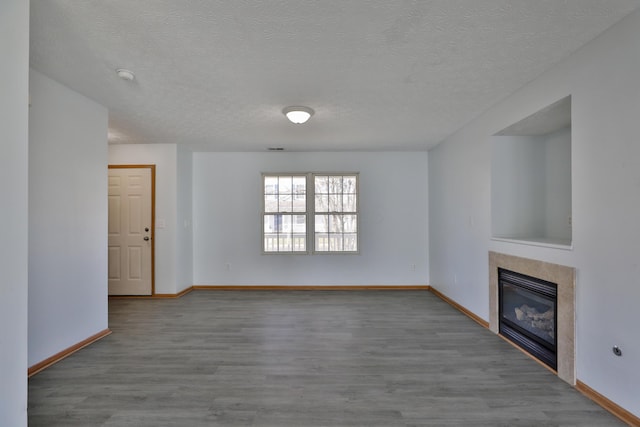 1852 Meadowlawn Dr, Columbus, OH 43219 - unfurnished living room with a tile fireplace, wood finished floors, and a textured ceiling