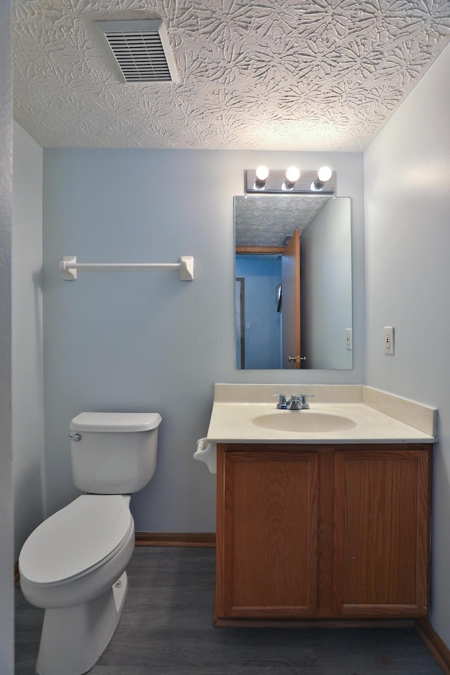 1852 Meadowlawn Dr, Columbus, OH 43219 - half bath featuring vanity, wood finished floors, and a textured ceiling