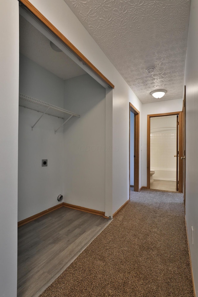 1852 Meadowlawn Dr, Columbus, OH 43219 - washroom with electric dryer hookup, a textured ceiling, carpet flooring, and wood finished floors