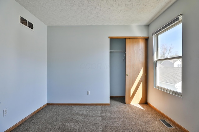 1852 Meadowlawn Dr, Columbus, OH 43219 - unfurnished bedroom with carpet, a closet, and a textured ceiling