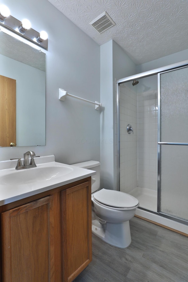 1852 Meadowlawn Dr, Columbus, OH 43219 - full bath featuring wood finished floors, vanity, a shower stall, and a textured ceiling