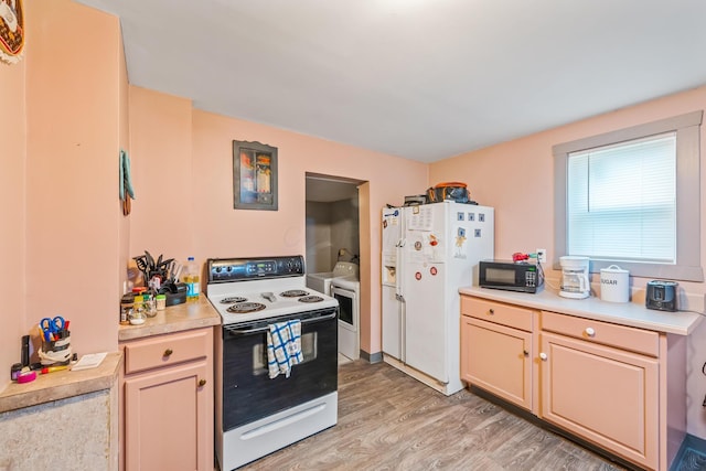 674 Sugar St, Marion, OH 43302 - kitchen with white appliances, washing machine and dryer, light wood-style flooring, and light countertops