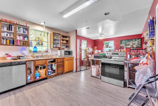 123 Deerwalk Cir, Marietta, OH 45750 - kitchen with stainless steel appliances, open shelves, light wood finished floors, light countertops, and a ceiling fan
