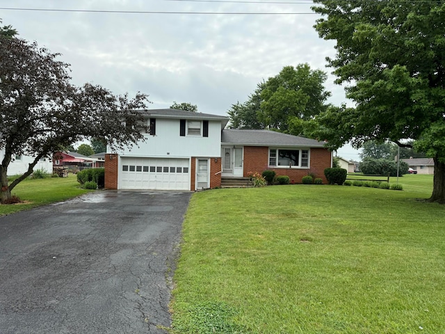 522 Carolyn Dr, Marion, OH 43302 - split level home with driveway, a garage, a front lawn, and brick siding
