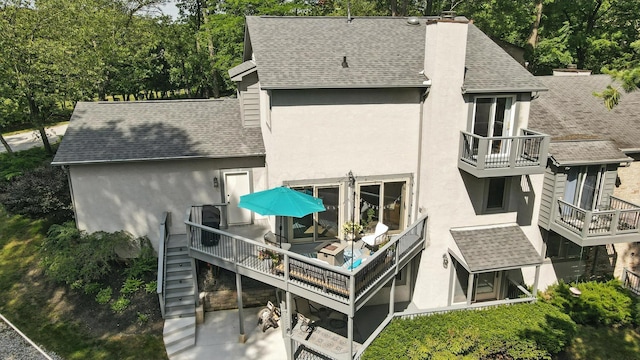 96 Executive Ct Unit B, Westerville, OH 43081 - back of property with stucco siding, a shingled roof, a chimney, and a balcony