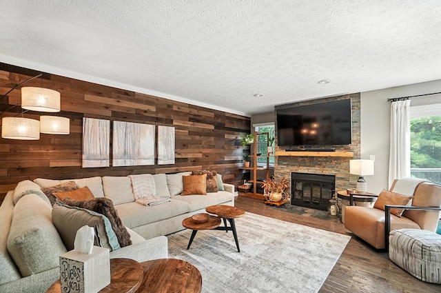 96 Executive Ct Unit B, Westerville, OH 43081 - living area featuring wooden walls, a textured ceiling, wood finished floors, and a fireplace
