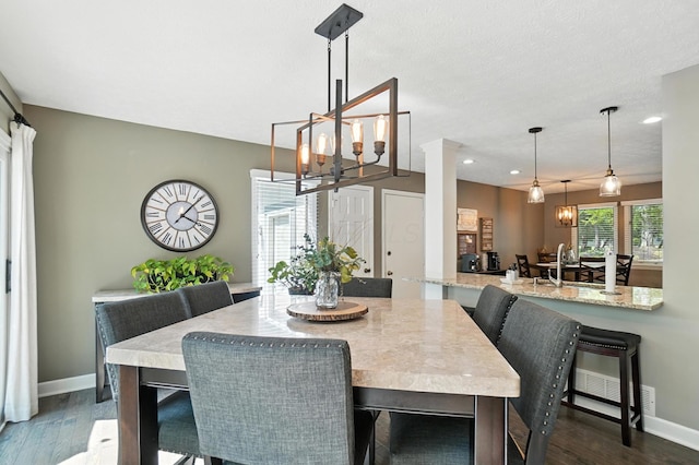 96 Executive Ct Unit B, Westerville, OH 43081 - dining space featuring a chandelier, recessed lighting, dark wood-style flooring, and ornate columns