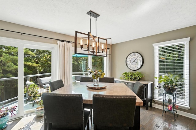 96 Executive Ct Unit B, Westerville, OH 43081 - dining area with a chandelier, dark wood-style floors, and a textured ceiling