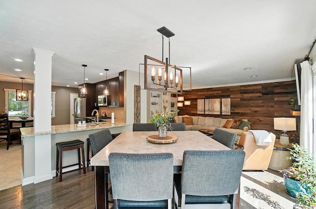96 Executive Ct Unit B, Westerville, OH 43081 - dining area with a chandelier, dark wood-style floors, wood walls, and recessed lighting