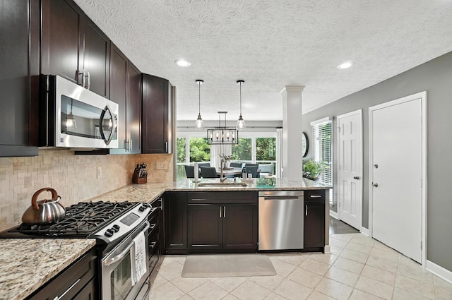 96 Executive Ct Unit B, Westerville, OH 43081 - kitchen featuring stainless steel appliances, tasteful backsplash, light stone countertops, dark brown cabinetry, and recessed lighting