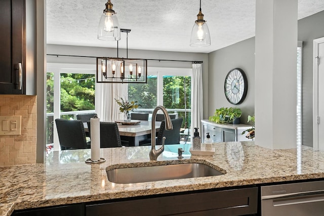 96 Executive Ct Unit B, Westerville, OH 43081 - kitchen with dark brown cabinets, plenty of natural light, backsplash, light stone countertops, and a textured ceiling