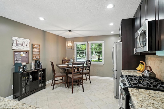 96 Executive Ct Unit B, Westerville, OH 43081 - dining space featuring recessed lighting, a textured ceiling, and a chandelier