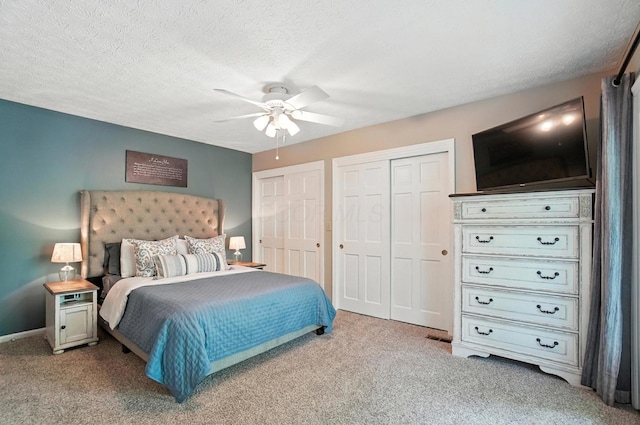 96 Executive Ct Unit B, Westerville, OH 43081 - carpeted bedroom with two closets, ceiling fan, and a textured ceiling