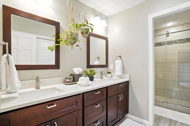 96 Executive Ct Unit B, Westerville, OH 43081 - full bath featuring double vanity, a shower stall, and wood finished floors