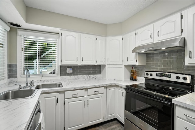96 Executive Ct Unit B, Westerville, OH 43081 - kitchen with appliances with stainless steel finishes, under cabinet range hood, white cabinets, backsplash, and light stone countertops