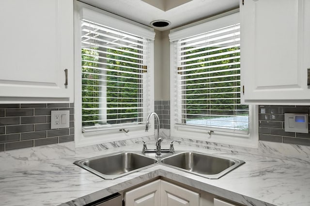 96 Executive Ct Unit B, Westerville, OH 43081 - kitchen with tasteful backsplash, white cabinetry, light countertops, and plenty of natural light