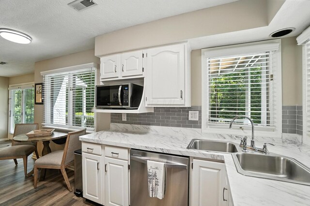 96 Executive Ct Unit B, Westerville, OH 43081 - kitchen featuring stainless steel appliances, white cabinetry, light countertops, dark wood-type flooring, and backsplash