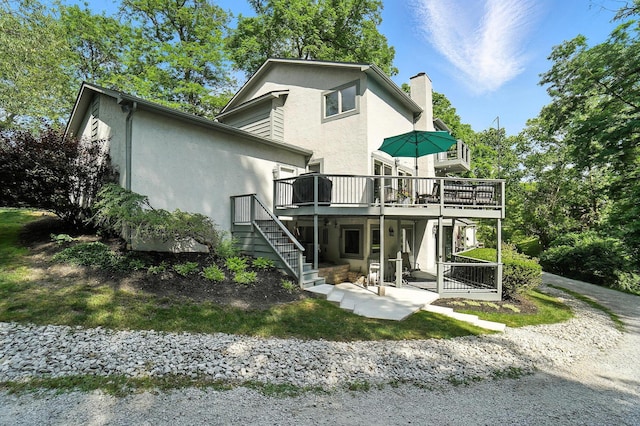 96 Executive Ct Unit B, Westerville, OH 43081 - back of house featuring stucco siding, stairway, a deck, a chimney, and a patio