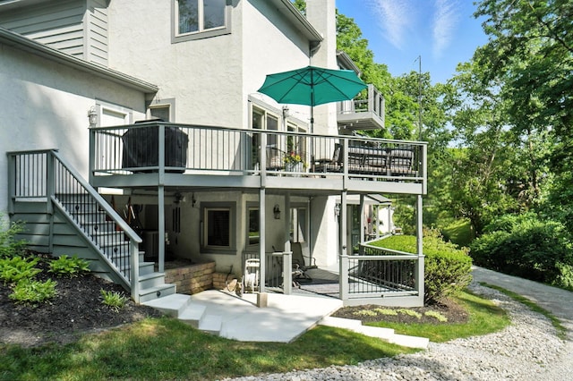 96 Executive Ct Unit B, Westerville, OH 43081 - back of property with stucco siding, stairway, a deck, and a patio