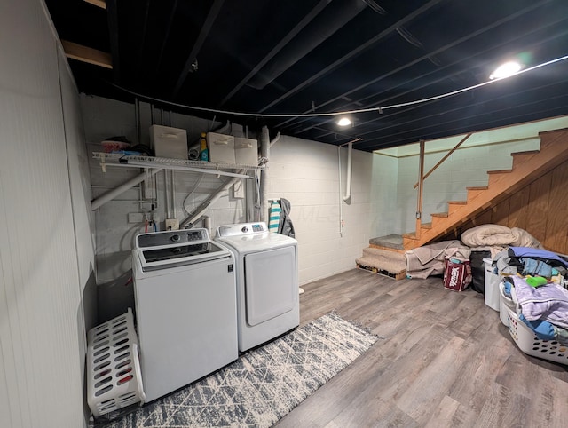 3439 Rough And Ready Rd, New Concord, OH 43762 - laundry room featuring washing machine and dryer, wood finished floors, and concrete block wall