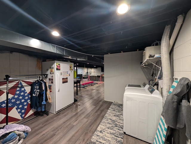 3439 Rough And Ready Rd, New Concord, OH 43762 - finished basement with washing machine and clothes dryer, freestanding refrigerator, wood finished floors, and concrete block wall