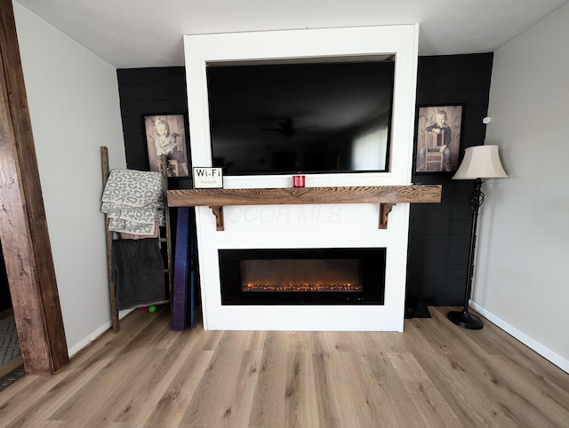 3439 Rough And Ready Rd, New Concord, OH 43762 - detailed view of wood finished floors, a glass covered fireplace, and a ceiling fan