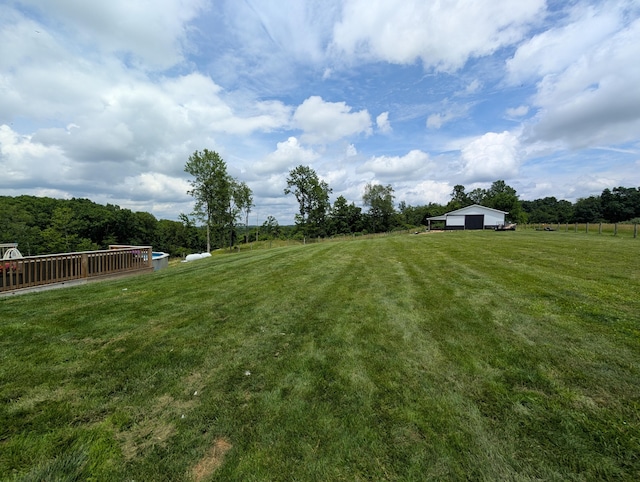 3439 Rough And Ready Rd, New Concord, OH 43762 - view of green lawn featuring an outbuilding, a rural view, and an outdoor structure