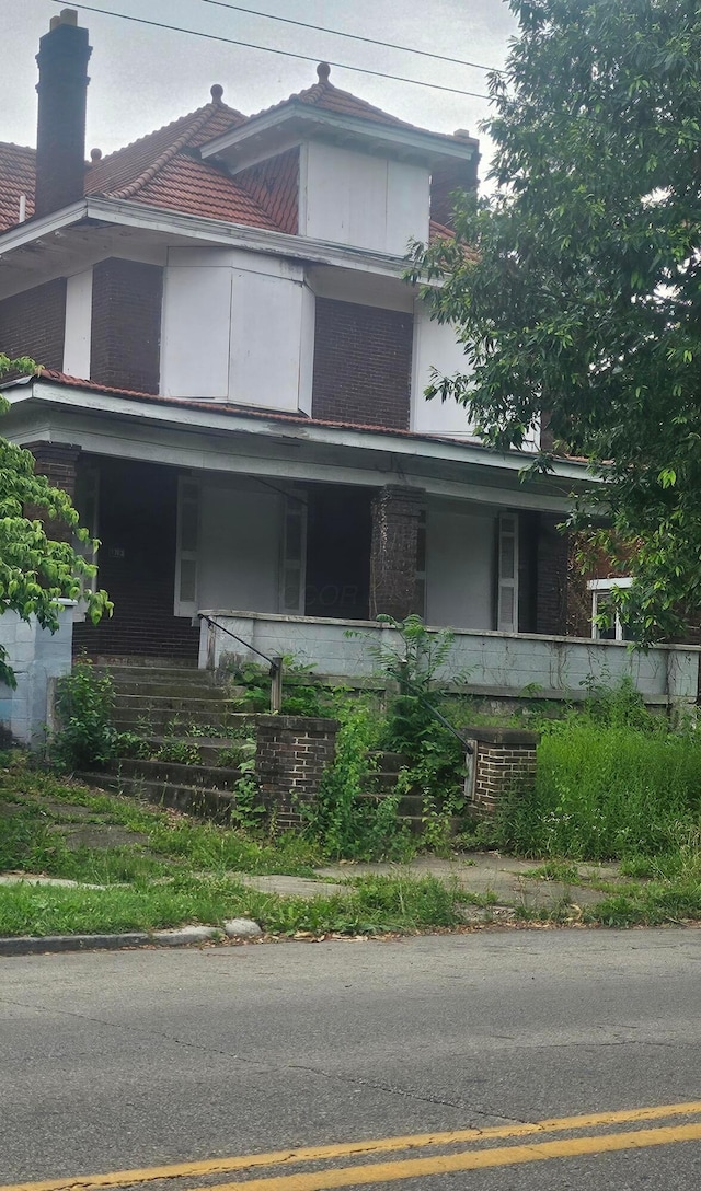1703 Bryden Rd, Columbus, OH 43205 - view of home's exterior featuring a porch, brick siding, and stairway