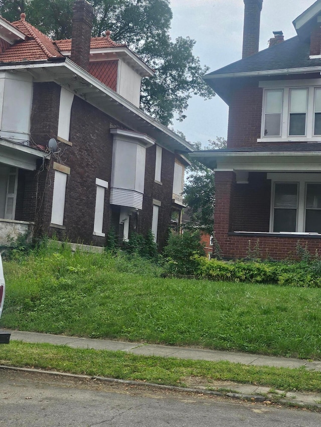 1703 Bryden Rd, Columbus, OH 43205 - view of property exterior featuring a chimney and brick siding
