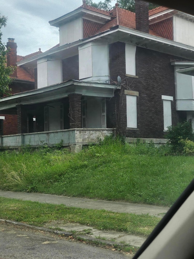 1703 Bryden Rd, Columbus, OH 43205 - view of side of home with a chimney and a porch