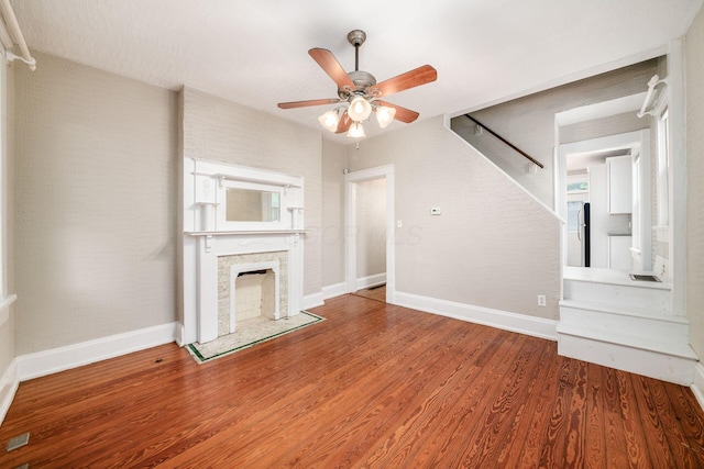 675-677 Beech St, Columbus, OH 43206 - unfurnished living room featuring ceiling fan, wood finished floors, and a fireplace