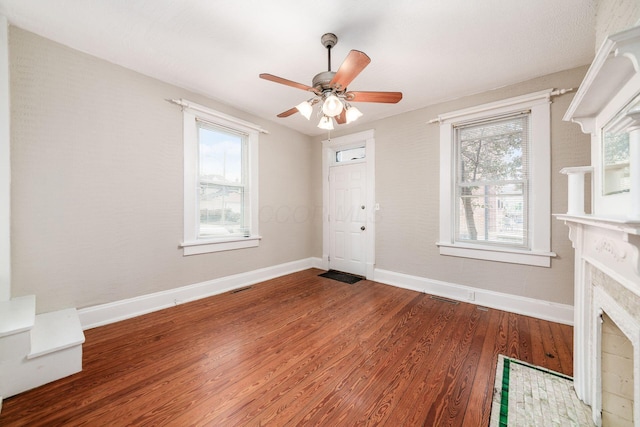 675-677 Beech St, Columbus, OH 43206 - unfurnished living room featuring wood finished floors, ceiling fan, and a tiled fireplace