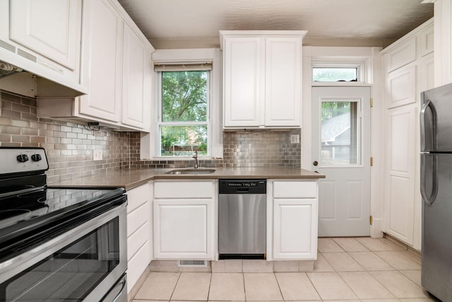 675-677 Beech St, Columbus, OH 43206 - kitchen featuring stainless steel appliances, backsplash, and white cabinetry