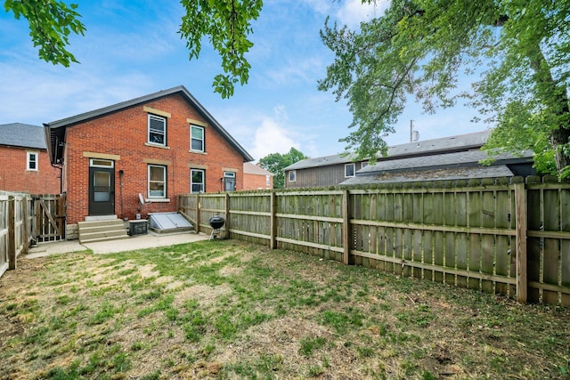 675-677 Beech St, Columbus, OH 43206 - back of house featuring brick siding, a fenced backyard, entry steps, and a patio