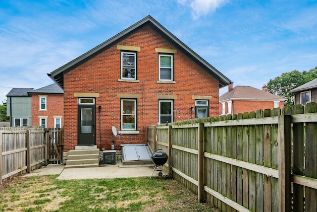 675-677 Beech St, Columbus, OH 43206 - back of house featuring brick siding, a fenced backyard, entry steps, and a patio area