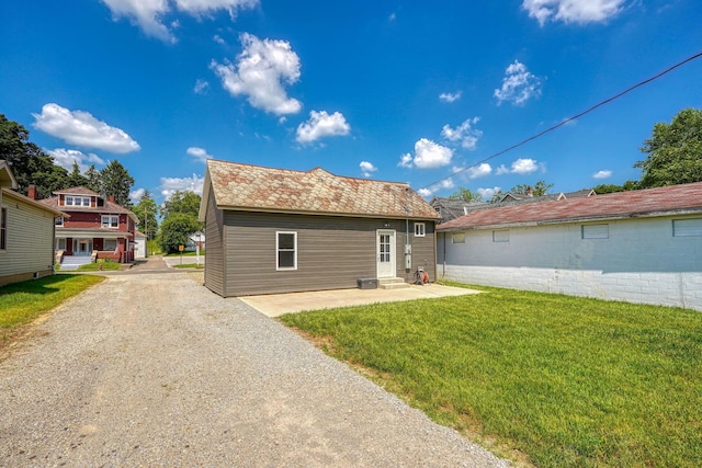 424 N Walnut St, Logan, OH 43138 - rear view of house featuring a lawn and a patio area