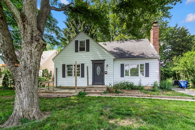 206 Lintner St, Columbus, OH 43230 - view of front of house with a front lawn, a chimney, and roof with shingles