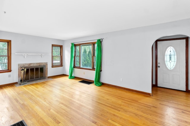 206 Lintner St, Columbus, OH 43230 - unfurnished living room with arched walkways, healthy amount of natural light, and light wood-type flooring