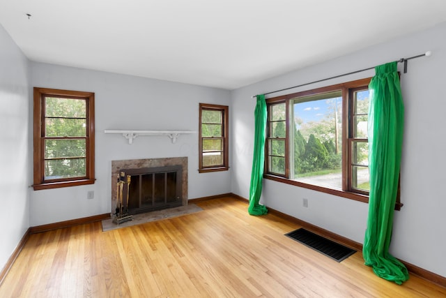 206 Lintner St, Columbus, OH 43230 - unfurnished living room with light wood finished floors and a high end fireplace