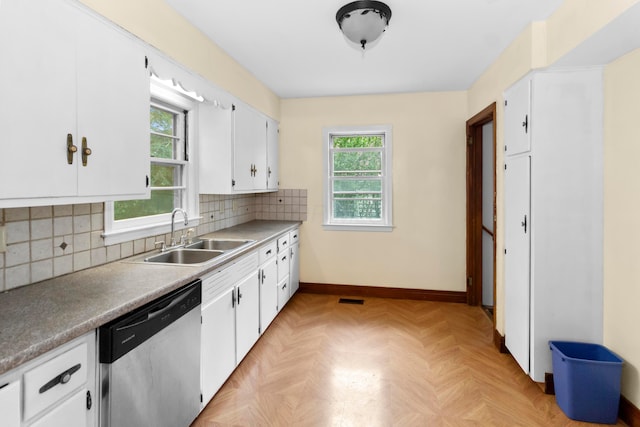 206 Lintner St, Columbus, OH 43230 - kitchen with stainless steel dishwasher, white cabinetry, and backsplash