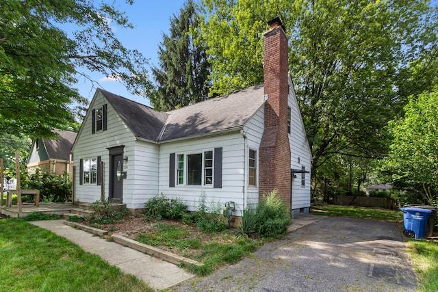 206 Lintner St, Columbus, OH 43230 - view of front of property featuring a chimney, a shingled roof, and asphalt driveway