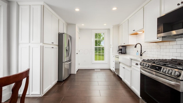 5377 Moots Run Rd, Alexandria, OH 43001 - kitchen with appliances with stainless steel finishes, decorative backsplash, recessed lighting, white cabinets, and dark tile patterned floors