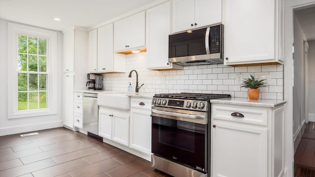 5377 Moots Run Rd, Alexandria, OH 43001 - kitchen with appliances with stainless steel finishes, decorative backsplash, white cabinetry, and recessed lighting