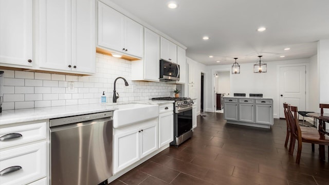 5377 Moots Run Rd, Alexandria, OH 43001 - kitchen featuring appliances with stainless steel finishes, tasteful backsplash, white cabinetry, recessed lighting, and pendant lighting