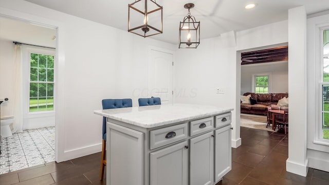 5377 Moots Run Rd, Alexandria, OH 43001 - kitchen featuring plenty of natural light, dark tile patterned flooring, decorative light fixtures, a center island, and recessed lighting