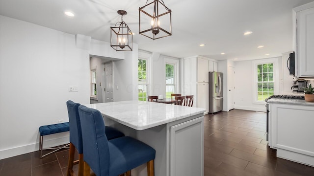 5377 Moots Run Rd, Alexandria, OH 43001 - kitchen with stainless steel refrigerator with ice dispenser, recessed lighting, white cabinetry, light stone counters, and a kitchen island
