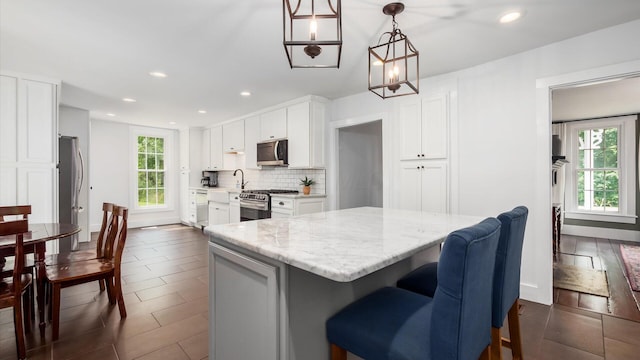 5377 Moots Run Rd, Alexandria, OH 43001 - kitchen with appliances with stainless steel finishes, plenty of natural light, light stone counters, recessed lighting, and backsplash